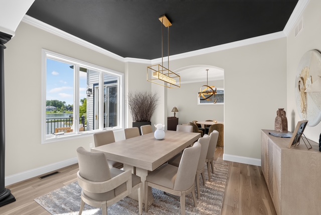 The formal dining room seating ten, with lake views through the picture window