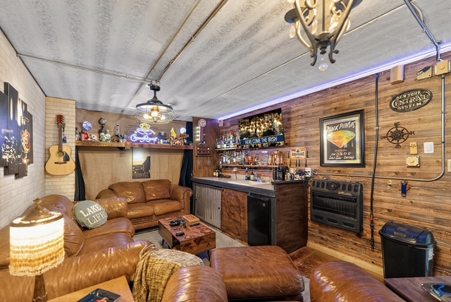 The EZ, the estate’s private speakeasy-style bar with reclaimed wood walls, leather lounge seating and a full back bar
